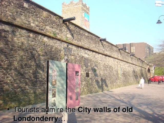 Tourists admire the City walls of old Londonderry …