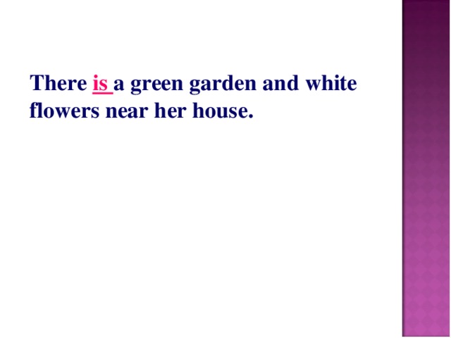 There is a green garden and white flowers near her house.