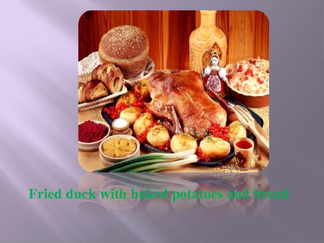 Fried duck with baked potatoes and bread 